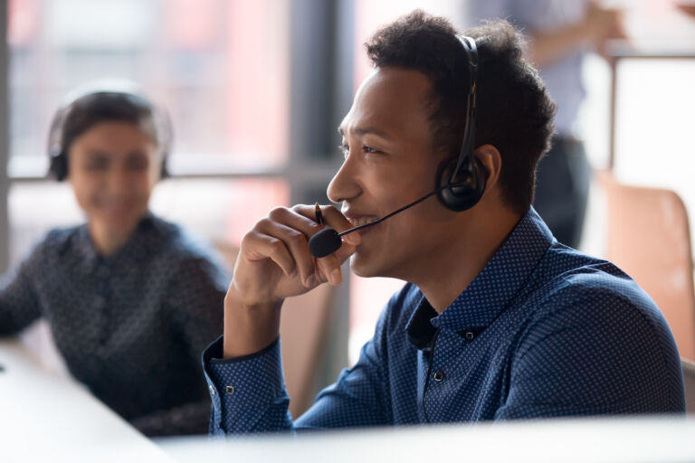 Smiling young african businessman call center agent laugh at workplace