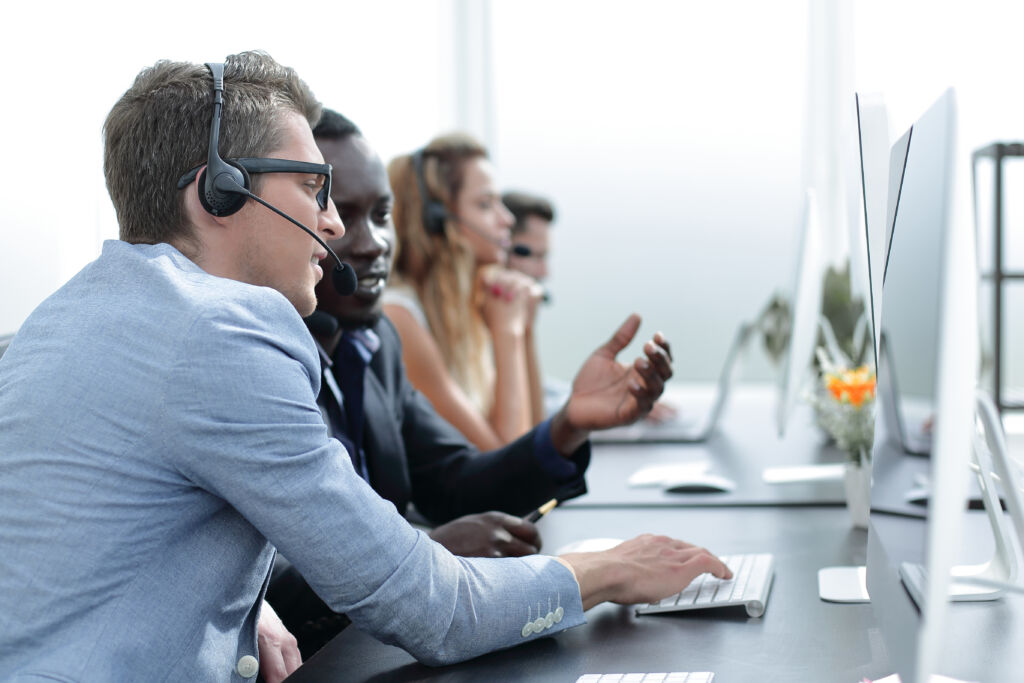 call center operators are talking, sitting at his Desk